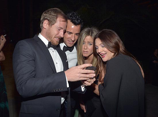 Drew Barrymore (à dir.) e seu marido mostram fotos do bebê recém-nascido a Jennifer Aniston e seu noivo em noite de Gala em Los Angeles 