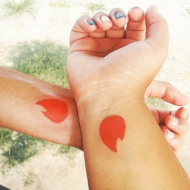 Casal que se conheceu no Tinder faz tatuagem com o símbolo do aplicativo