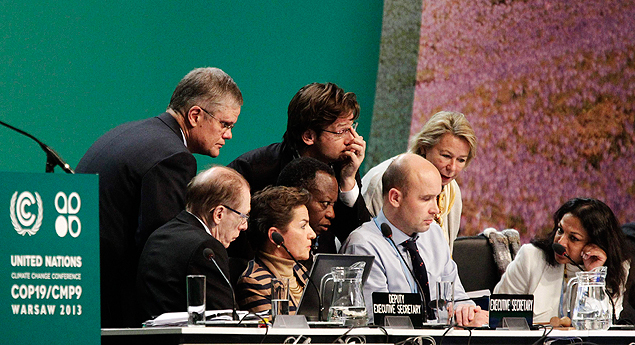 O presidente da COP-19, Marcin Korolec (no centro), cercado por secretrios e assistentes no ltimo dia da conferncia do clima