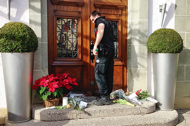 A security guard closes the door of the Restaurant de l'Hotel de Ville in Crissier near Lausanne, western Switzerland, on February 1, 2016, near flowers placed at the entrance of the restaurant a day after its chef was found dead at his home. Top chef Benoit Violier -- whose renowned three-star restaurant in a small Swiss town is seen as the world's best -- was found dead in his home on January 31 in an apparent suicide, police said. News of the 44-year-old's death, just months after his Restaurant de l'Hotel de Ville was crowned the 