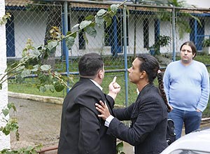 Ex-pacientes de clínica acusam o dono, Marcelo Oliveira (de blusa azul), de tortura, em frente à unidade que foi desativada