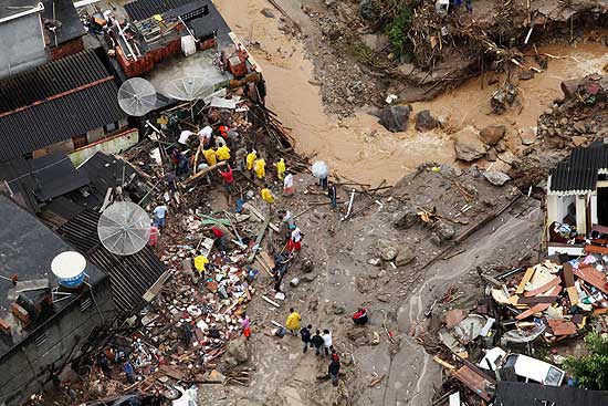 Moradores e homens da Defesa Civil, procuram sobreviventes das enchentes na regio serrana do Rio de Janeiro