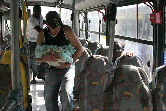 Rafael Nascimento Araújo, 20, leva seu filho para hospital após sua mulher dar à luz em uma estação de trem