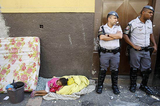 Famlias deixam imvel durante reintegrao de posse em So Paulo; imagem mostra menina deitada em calada