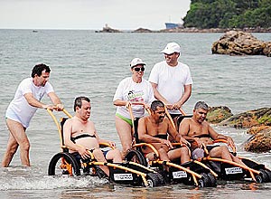 Wheelchair users in amphibious beach in San Sebastian
