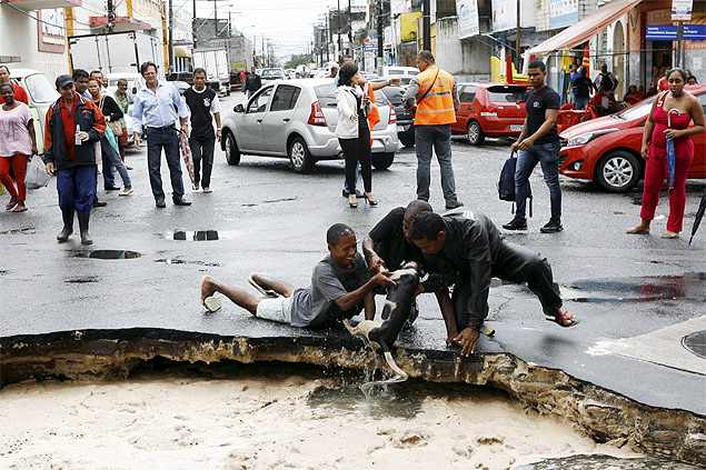 Cachorro  retirado de cratera aps asfalto ceder em Salvador; chuva provoca alagamentos, deslizamento e quedas de rvores
