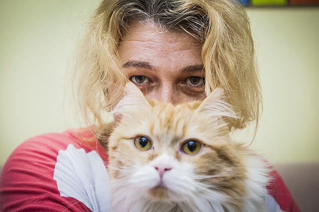 Retrato da funcionria publica Rosngela Oliveira com seu gato em sua casa no bairro Moema em So Paulo