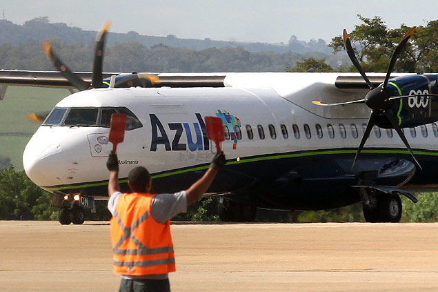 Operador sinaliza para piloto durante manobra de avio no aeroporto de Ribeiro Preto