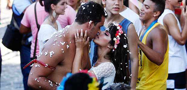 REFILE - CORRECTING GRAMMAR Revellers kiss each other during the annual block party known as "Carmelitas" in Rio de Janeiro February 13, 2015. Contrary to a common stereotype, Brazil is a socially conservative nation, its culture rooted in Catholic tradition. Many view the five-day Carnival as the one chance to enjoy a bit of hedonism before the solemn period of Lent begins on Ash Wednesday. Some locals measure that freedom in kisses, competing with their friends to see who can smooch 10, 20, even 30 different people in a single outing. Picture taken on February 13, 2015. REUTERS/Pilar Olivares (BRAZIL - Tags: SOCIETY) ORG XMIT: BRA203