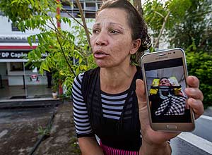 Geidiane de Souza, 33, mostra foto em seu celular em que aparece desfigurada, aps ser espancada pelo ex-marido em maio