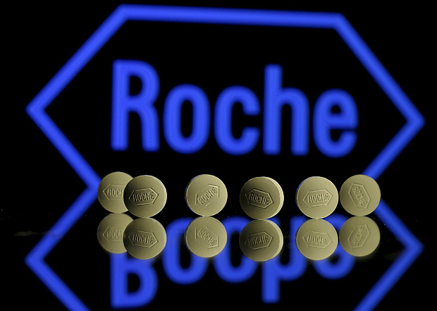 Roche tablets are seen positioned in front of a displayed Roche logo in this photo illustration shot January 22, 2016. REUTERS/Dado Ruvic/Illustration/File Photo ORG XMIT: LONX102