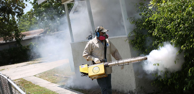 MIAMI, FL - AUGUST 02: Carlos Varas, a Miami-Dade County mosquito control inspector, uses a Golden Eagle blower to spray pesticide to kill mosquitos in the Wynwood neighborhood as the county fights to control the Zika virus outbreak on August 2, 2016 in Miami, Florida. There is a reported 14 individuals who have been infected with the Zika virus by local mosquitoes. Joe Raedle/Getty Images/AFP == FOR NEWSPAPERS, INTERNET, TELCOS & TELEVISION USE ONLY ==