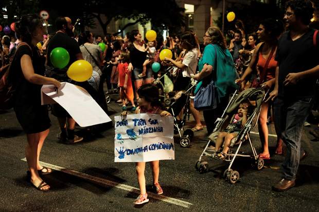 A child holds a sign reading 