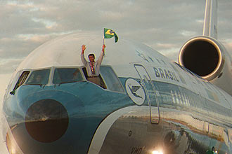 Herói do tetra, Romário segura bandeira em avião