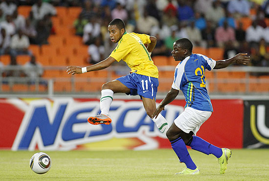 Brazil's Robinho, left, shoots past Tanzania's Stephano Mwasika to score the first goal in their friendly soccer match in Dar es Salaam, Tanzania Monday, June 7, 2010. Brazil are preparing for the upcoming World Cup, where they will play in Group G. (AP Photo/Rebecca Blackwell)
