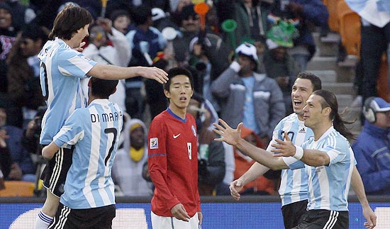 Argentina's Lionel Messi, left, celebrates with teammates including Argentina's Martin Demichelis, right, and Argentina's Angel Di Maria during the World Cup group B soccer match between Argentina and South Korea at Soccer City in Johannesburg, South Africa, Thursday, June 17, 2010. (AP Photo/Ivan Sekretarev)