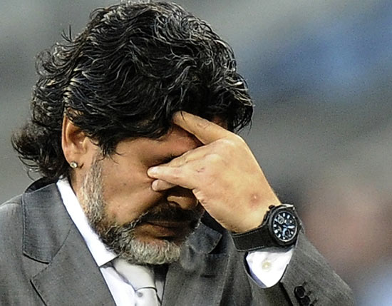 Argentina's coach Diego Maradona reacts during their 2010 World Cup quarter-final soccer match against Germany at Green Point stadium in Cape Town July 3, 2010. REUTERS/Darren Staples (SOUTH AFRICA - Tags: SPORT SOCCER WORLD CUP)