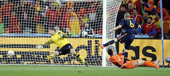 Spain's Andres Iniesta, right, scores a goal past Netherlands goalkeeper Maarten Stekelenburg, left, during the World Cup final soccer match between the Netherlands and Spain at Soccer City in Johannesburg, South Africa, Sunday, July 11, 2010. (AP Photo/Daniel Ochoa de Olza)