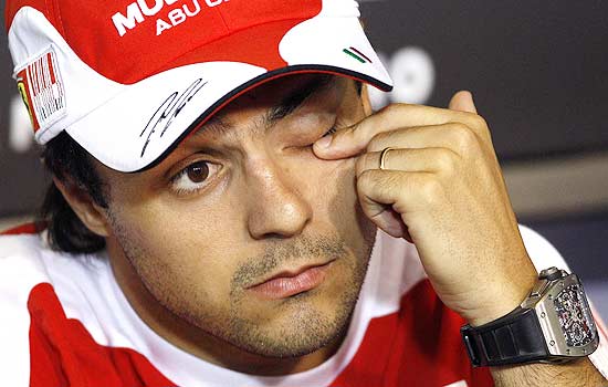 Ferrari Formula One driver Felipe Massa of Brazil rubs his eye during a news conference at the Hungaroring circuit near Budapest July 29, 2010, ahead of the Hungarian F1 Grand Prix. REUTERS/Max Rossi (HUNGARY - Tags: SPORT MOTOR RACING)