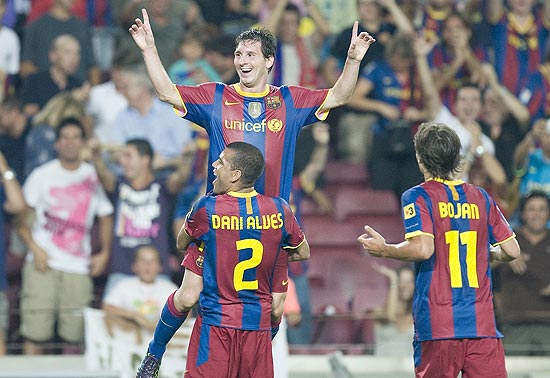 FC Barcelona's Lionel Messi from Argentina celebrates with his teammate Daniel Alves from Brazil after scoring against Sevilla during their Supercup final second leg soccer match at the Camp Nou stadium in Barcelona, Spain, Saturday, Aug. 21, 2010. (AP Photo/David Ramos)