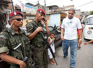 Adriano ( à dir.) passa por soldados durante visita a Vila Cruzeiro