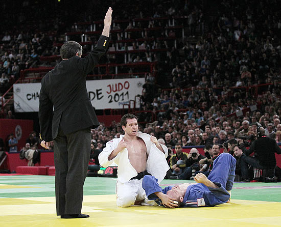 ORG XMIT: MMD032680 Brazilian Tiago Camilo celebrates after winning against French Romain Buffet during the Men's under 90kg Semi-Final fight on February 6, 2011 at the Paris International Judo Tournament at the Palais omnisports de Paris-Bercy. Nishiyama won the fight. AFP PHOTO/JACQUES DEMARTHON