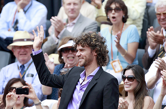 Gustavo Kuerten é aplaudido ao chegar na quadra central para acompanhar a final de Roland Garros