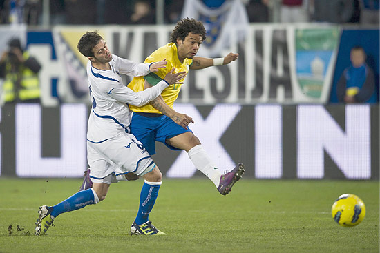 Marcelo, da seleção brasileira chuta a bola e é empurrado por Miralem Pjanic 