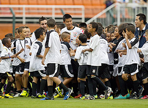 Chinês Zizao é cercado por crianças antes de entrar em campo pelo Corinthians; partida acabou com vitória da Ponte Preta