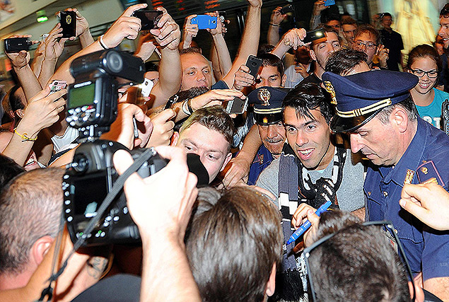 O atacante argentino Carlos Tevez  cercado por torcedores no aeroporto de Milo, na Itlia