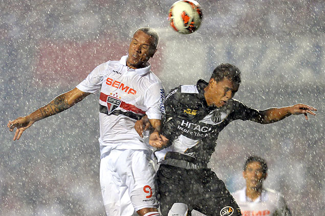 O lateral direito Artur ( direita), da Ponte Preta, disputa a bola com o atacante Luis Fabiano, do So Paulo, no Morumbi