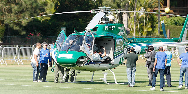 Na maca, o atacante Neymar é levado de helicóptero da Granja Comary