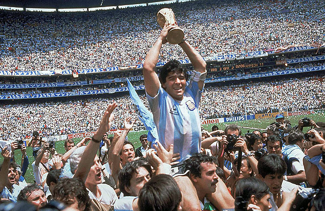 FILE - In this June 29, 1986, file photo, Diego Maradona, holds up the trophy, after Argentina beat West Germany 3-2 in their World Cup soccer final match, at the Atzeca Stadium, in Mexico City. On Sunday, July 13, 2014, Germany and Argentina will face each other again in the final of the 2014 soccer World Cup.(AP Photo/Carlo Fumagalli, File) ORG XMIT: WCFO103