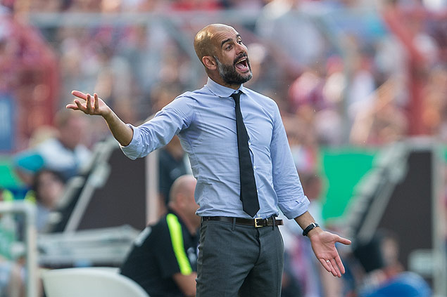 Munich's coach Pep Guardiola gestures during the German soccer cup first round match between fifth tier team FC Noettingen and Bayern Munich in Karlsruhe, southern Germany, Sunday, Aug. 9, 2015. (AP Photo/Daniel Maurer) ORG XMIT: KAR118