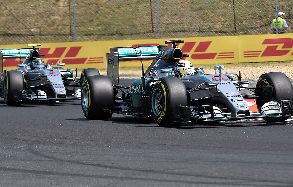 Mercedes AMG Petronas F1 Team's British driver Lewis Hamilton (R) drives ahead of his teammate German driver Nico Rosberg (L) during the third practice session on July 25, 2015 at the Hungaroring circuit near Budapest on the eve of the Hungarian Formula One Grand Prix. AFP PHOTO / ATTILA KISBENEDEK ORG XMIT: ATT9074