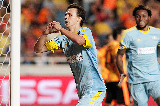 FC Astana's Nemanja Maksimovic, left, celebrates his goal against Apoel Nicosia during a Champions League second leg play-off match between APOEL Nicosia and Astana Kazakhstan at GSP stadium, in Nicosia, Cyprus, Wednesday, Aug. 26, 2015. Astana FC advanced to the Champions League group stage for the first time since its founding six years ago after earning a 1-1 away draw with the Cyprus champion. (AP Photo/Petros Karadjias) ORG XMIT: XPK110