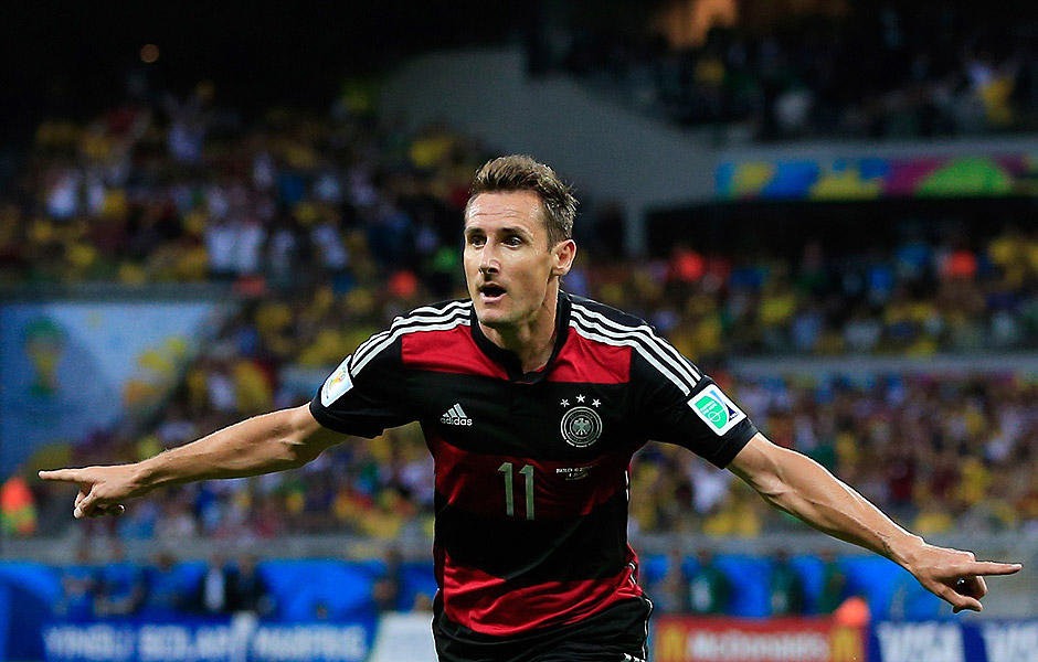 Germany's forward Miroslav Klose celebrates after scoring during the semi-final football match between Brazil and Germany at The Mineirao Stadium in Belo Horizonte during the 2014 FIFA World Cup on July 8, 2014. AFP PHOTO / ADRIAN DENNIS ORG XMIT: 001