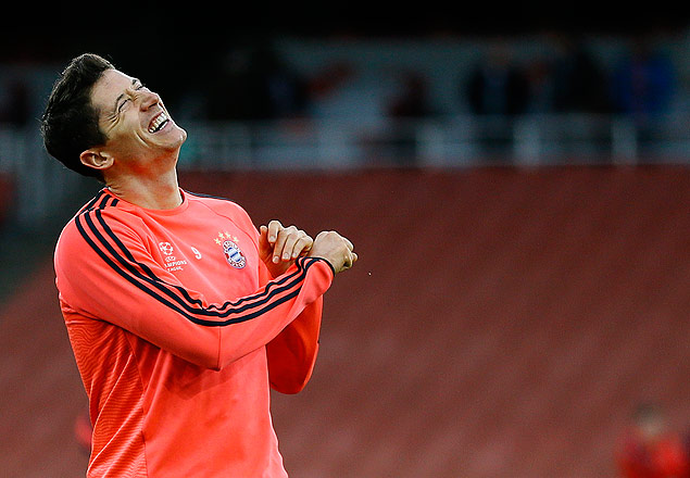 Bayern's Robert Lewandowski laughs during a soccer training session at Emirates stadium in London Monday, Oct. 19, 2015. Arsenal will play Bayern Munich in a Champions League Group F soccer match at the stadium on Tuesday. (AP Photo/Kirsty Wigglesworth) ORG XMIT: LKW113