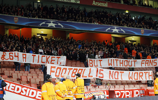 Some of Munich soccer supporters leave their seats and protest against high ticket prizes at the beginning of the Champions League Group F soccer match between Arsenal and Bayern Munich at Emirates stadium in London Tuesday, Oct. 20, 2015. (AP Photo/Kirsty Wigglesworth) ORG XMIT: FAS101