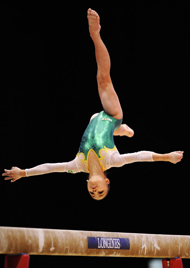Flavia Lopes Saraiva of Brazil competes on the beam during the first day of qualifications at the 2015 World Gymnastics Championship in Glasgow, Scotland, on October 23, 2015. Gymnasts can secure qualification for the 2016 Rio Games at the championships which will be staged at the Hydro Arena. AFP PHOTO / ANDY BUCHANAN ORG XMIT: 5581