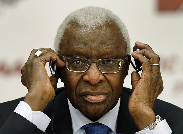 FILE - In this Aug. 21, 2015 file photo IAAF president Lamine Diack adjusts his headphones during a joint IOC and IAAF press conference on the side of the World Athletic Championships in Beijing. IOC ethics panel recommends provisional suspension of Lamine Diack as honorary member, Monday, Nov. 9, 2015. (AP Photo/Kin Cheung, file) ORG XMIT: LGL108