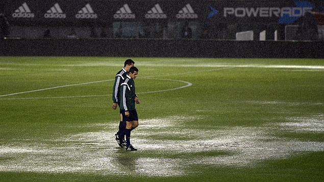 FIFA referees check the field before the Russia 2018 FIFA World Cup South American Qualifiers football match Argentina vs Brazil, in Buenos Aires, on November 12, 2015. The match has been cancelled due to heavy rains and will be held on November 13. AFP PHOTO / JUAN MABROMATA ORG XMIT: MMV075