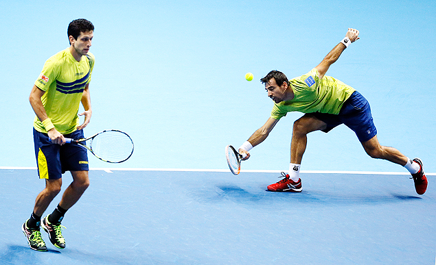 Ivan Dodig of Croatia, right, and Marcelo Melo of Brazil, left, play a return to Pierre-Hugues Herbert of France and Nicolas Mahut of France during their doubles tennis match at the ATP World Tour Finals at the O2 Arena in London, Monday, Nov. 16, 2015. (AP Photo/Kirsty Wigglesworth) ORG XMIT: LKW130
