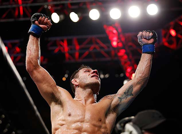 FILE - In this March 15, 2015, file photo, Rafael dos Anjos celebrates after winning the men's lightweight mixed martial arts title bout against Anthony Pettis at UFC 185 in Dallas. Anjos defends his UFC lightweight title belt against Donald Cerrone in Orlando, Fla., on Saturday, Dec. 19, in a meeting of two fighters who traveled lengthy roads to their showdown. (AP Photo/Brandon Wade, File) ORG XMIT: NY150