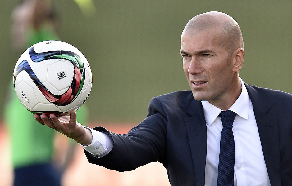 Former French football star and coach of Real Madrid Castilla Zinedine Zidane catches a ball during the Spanish league second division football match Real Madrid Castilla vsTalavera de la Reina at the Alfredo di Stefano Stadium in Valdebebas on the outskirts of Madrid on December 19, 2015. AFP PHOTO / GERARD JULIEN ORG XMIT: GJ4691