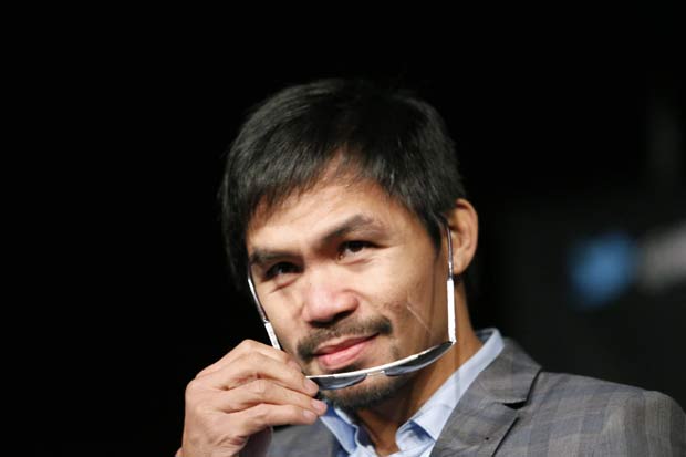 (FILES) This file photo taken on January 21, 2016 shows boxer Manny Pacquiao at a press conference in New York. US sports equipment giant Nike on February 17, 2016 severed its relationship with Manny Pacquiao, lashing out at the Filipino boxer's remarks in which he described homosexuals as "worse than animals.""We find Manny Pacquiao's comments abhorrent," a Nike statement said. "Nike strongly opposes discrimination of any kind and has a long history of supporting and standing up for the rights of the LGBT community. / AFP / KENA BETANCUR ORG XMIT: KB01