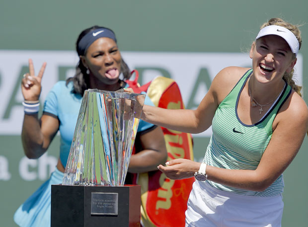 Serena Williams, left, jokes as Victoria Azarenka, of Belarus, right, poses with the trophy after a finals match at the BNP Paribas Open tennis tournament, Sunday, March 20, 2016, in Indian Wells, Calif. Azarenka won, 6-4, 6-4. (AP Photo/Mark J. Terrill) ORG XMIT: IWT114