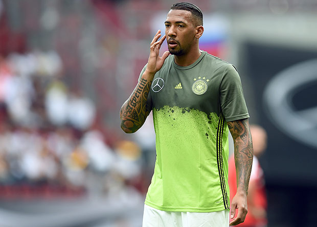 Germany's defender Jerome Boateng wipes his face during the friendly football match between Germany and Slovakia in Augsburg, southern Germany, on May 29, 2016. / AFP PHOTO / CHRISTOF STACHE ORG XMIT: CST048