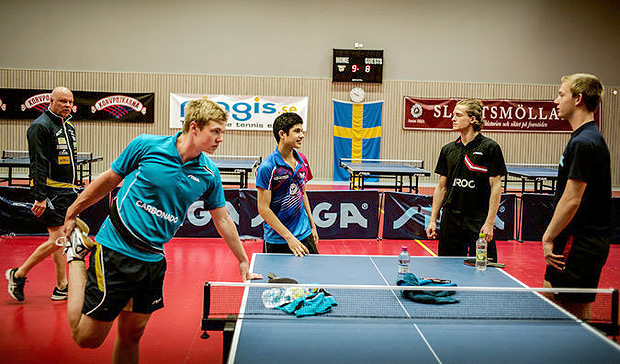 Jha, at left corner of the table, and other players in Halmstad. Ulf Carlsson, a coach, is at the far left. Credit Carsten Snejbjerg for The New York Times 