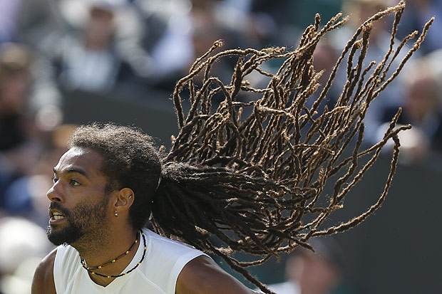 (160702) -- LONDON, July 2, 2016 (Xinhua) -- Dustin Brown of Germany serves to Nick Kyrgios of Australia during their men's singles second round match at the Wimbledon Tennis Championships in London, Britain, on July 1, 2016. Brown lost the match 2-3. (Xinhua/Ye Pingfan)(zc)